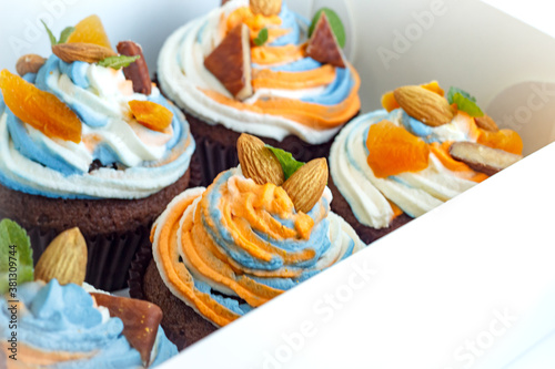 Fresh tricolor cream cupcakes in a white package