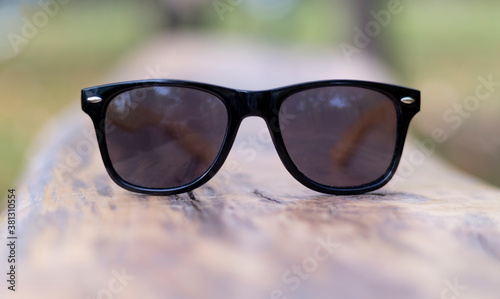polarized glasses on a wall with a blurred background. brand of sunglasses and eyeglasses designed for aviators by Bausch & Lomb