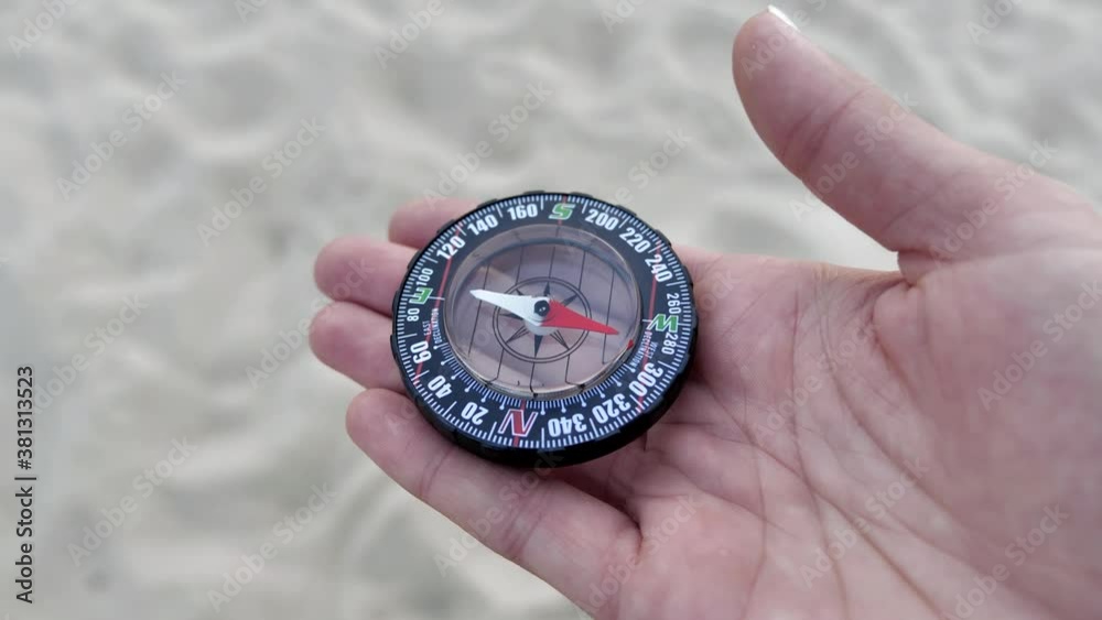 Tourist compass on the hand of sand background 4k Tourist compass on the hand of sand background 4k