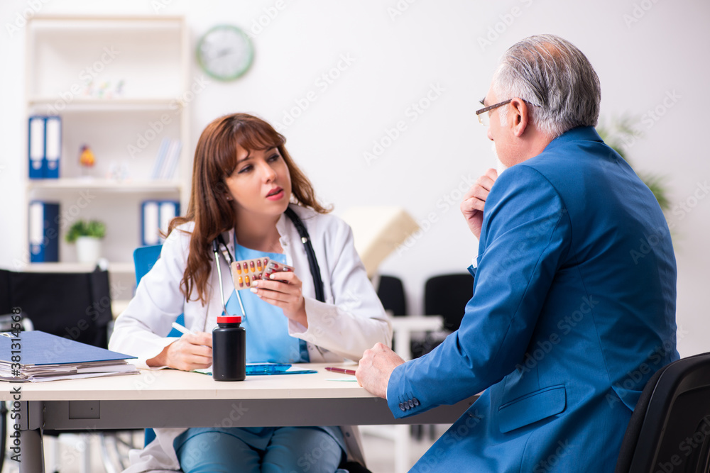 Fototapeta premium Old businessman visiting young female doctor