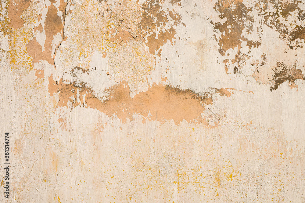 Grunge background of cracked cloud peeled putty wall in beige tones