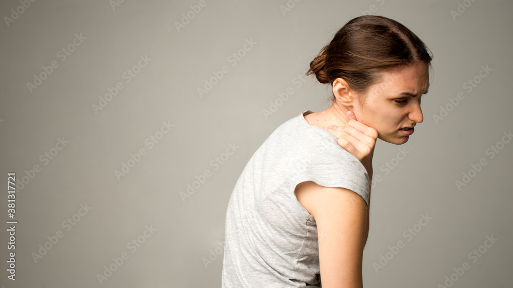 Obraz premium Tired woman feeling pain, massaging tense muscles