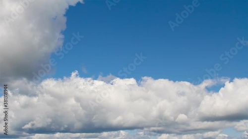 White cumulus clouds motion on the blue sky background. Time Lapse.