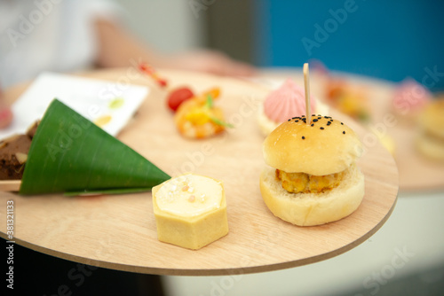 canapes finger food on wooden platter