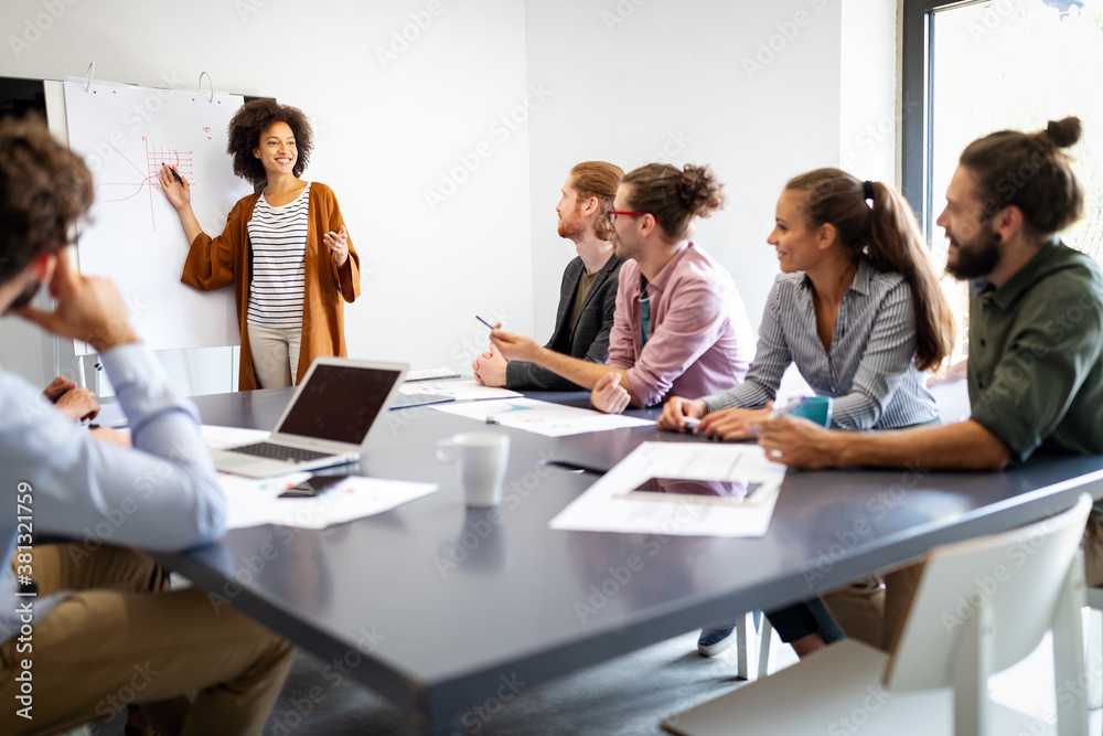 Businesspeople discussing together in conference room during meeting at office Businesspeople discussing together in conference room during meeting at office