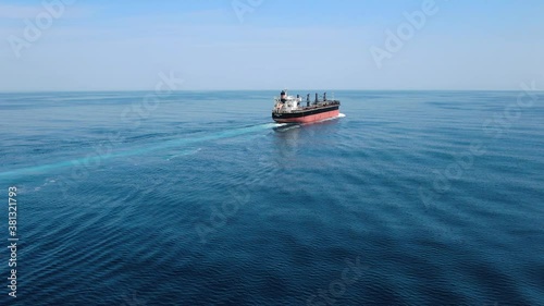Large cargo ship. A bulk carrier carries cargo across the ocean. Transportation. Delivery. Logistics. A large ship for transporting. Aerial 4k shot.