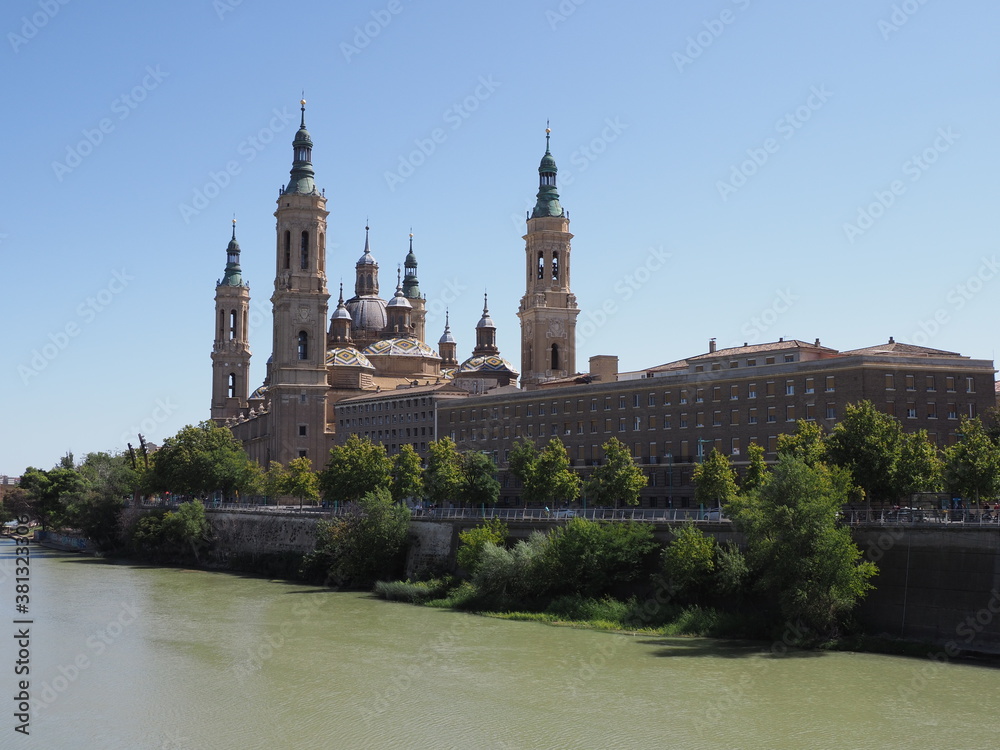 Scenic Basilica of Our Lady of the Pillar and Ebro river in european Saragossa city at Aragon district in Spain, clear blue sky in 2019 warm sunny summer day on September.