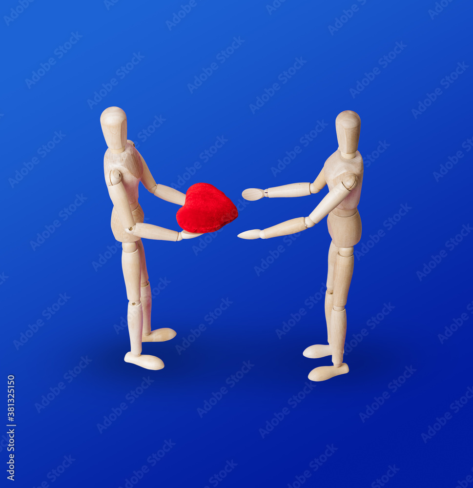 Wooden toy figures with heart on blue Wooden toy figures with heart on blue