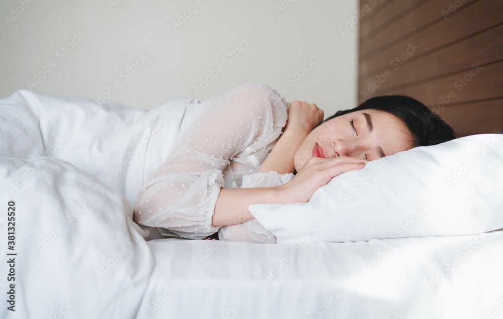 Young beautiful Asian woman sleeping on bed in the morning Young beautiful Asian woman sleeping on bed in the morning