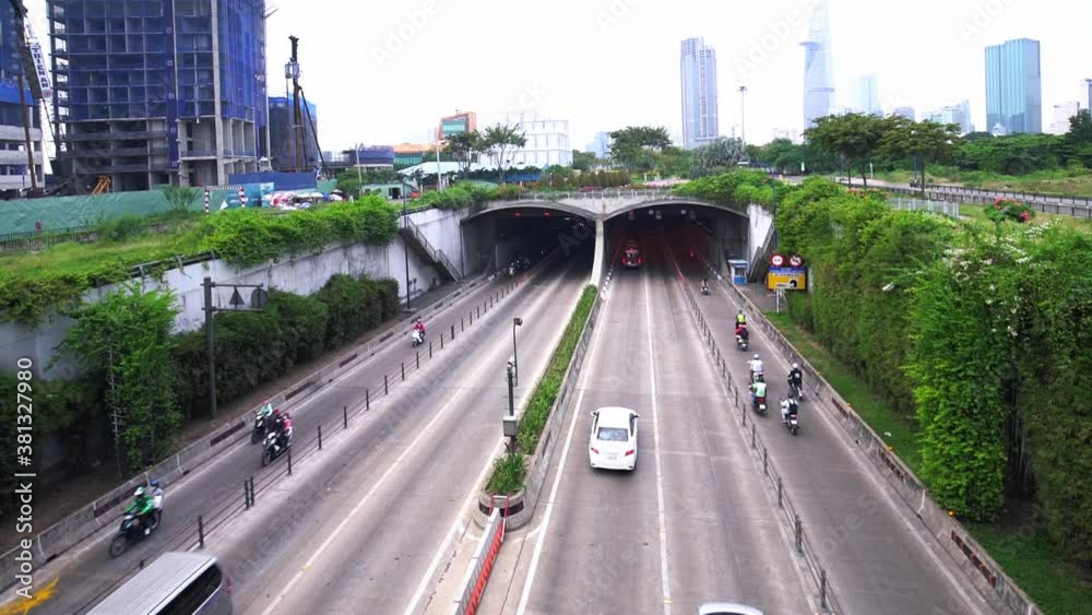 Crowded traffic at Thu Thiem tunnel exit on a sunny morning. This is an economic transport project across the Saigon river in Ho Chi Minh City, Vietnam