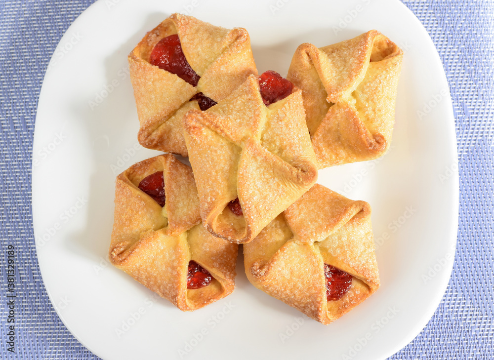 Homemade cookies with jam on a white plate. Selective focus, blurred background. Homemade cookies with jam on a white plate. Selective focus, blurred background.