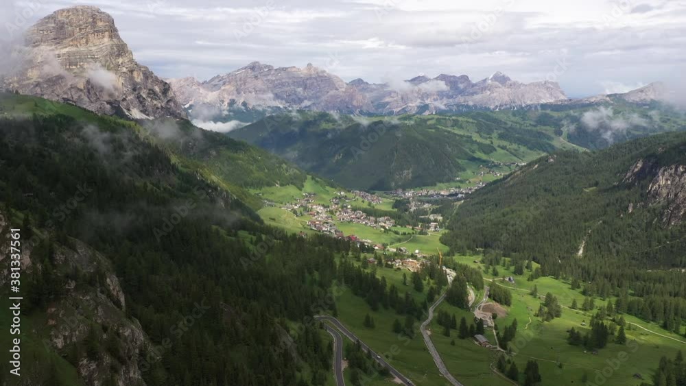 Flying towards small mountain village on beautiful location surrounded by peaks of the Dolomites in Italy
Flying towards small mountain village on beautiful location surrounded by peaks of the Dolomites in Italy
