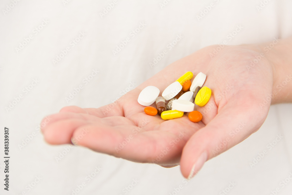 multicolored pills lie in hand multicolored pills lie in hand