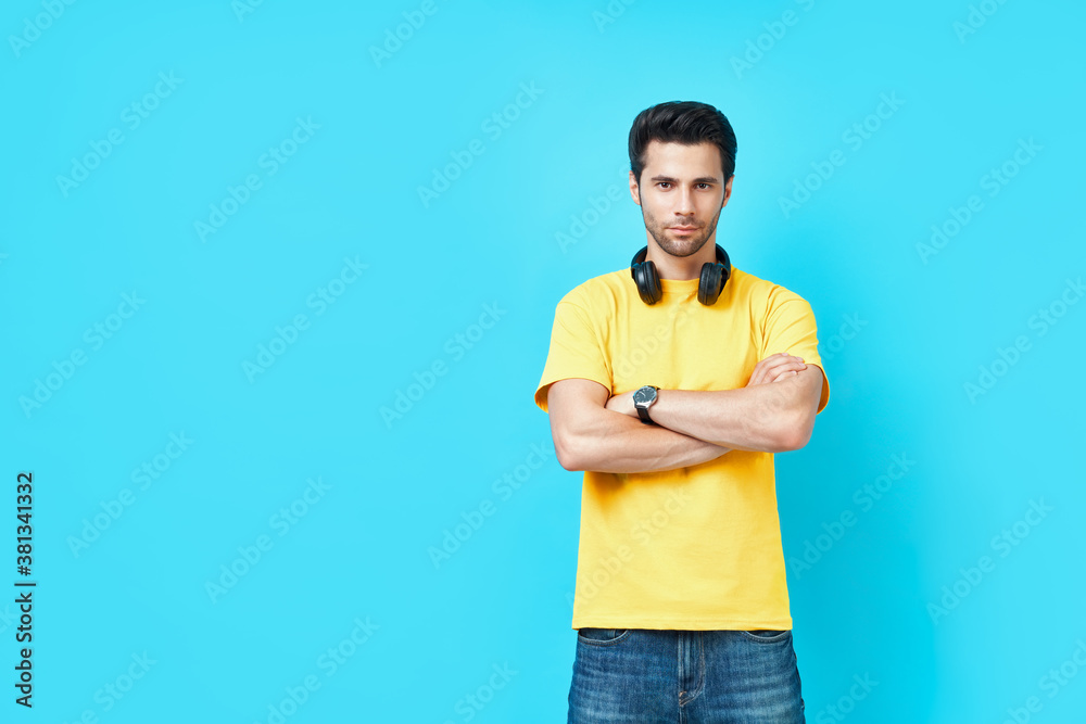 Young trendy handsome man with crossed arms looking to camera Young trendy handsome man with crossed arms looking to camera
