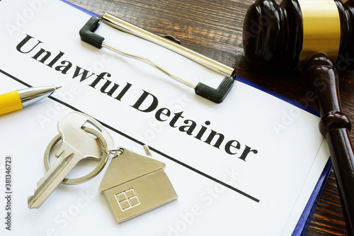 Unlawful detainer papers, key and gavel in the court.