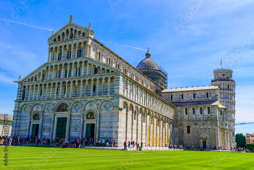 Pisa Cathedral (Duomo di Pisa) with Leaning Tower of Pisa on Piazza dei Miracoli in Pisa, Tuscany, Italy. World famous tourist attraction and travel destination.