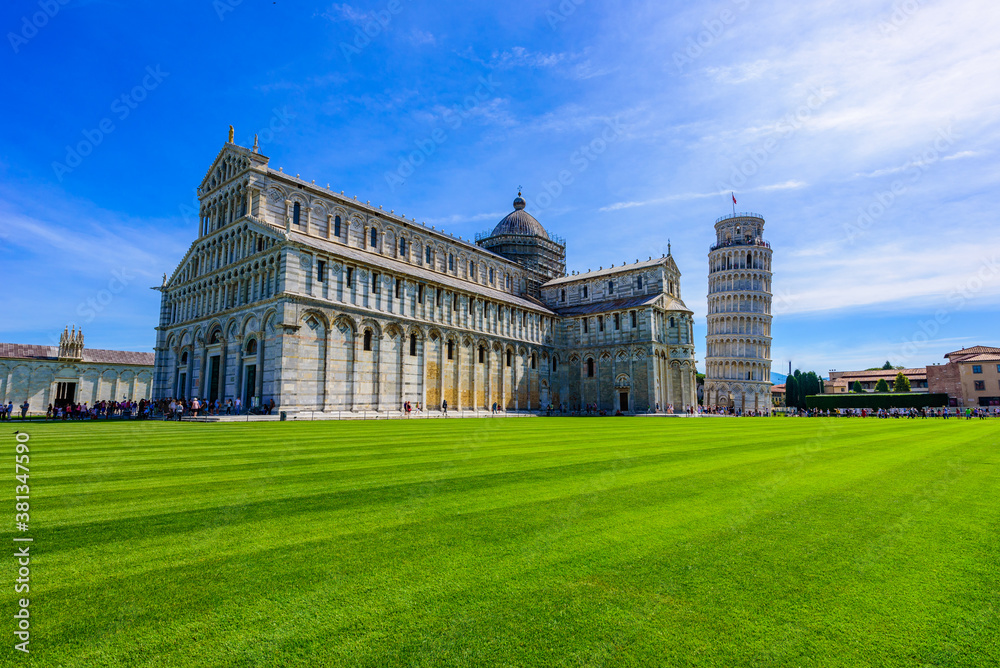 Pisa Cathedral (Duomo di Pisa) with Leaning Tower of Pisa on Piazza dei Miracoli in Pisa, Tuscany, Italy. World famous tourist attraction and travel destination.