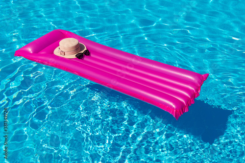 Beach summer holiday background. Inflatable air mattress and hat on swimming pool.  © nata777_7