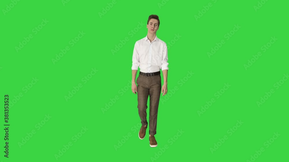Handsome young wearing white shirt walking on a Green Screen, Chroma Key. Handsome young wearing white shirt walking on a Green Screen, Chroma Key.