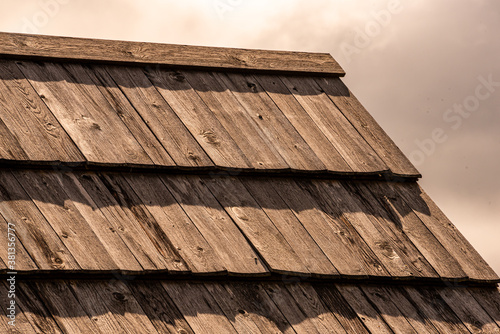 Interesting larch shingle roofs on the roof of a mountain hut