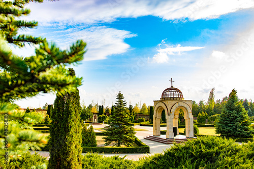 Memorial from Moldova. Landscape, fir trees, green background © Alexandru