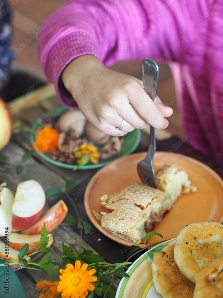 Rustic style. Thanksgiving day celebration concept. There is a lot of food on the wooden table. Guests take healthy homemade natural food with their hands.