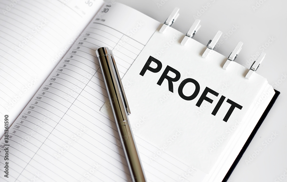 text PROFIT on the short note texture background with pen text PROFIT on the short note texture background with pen