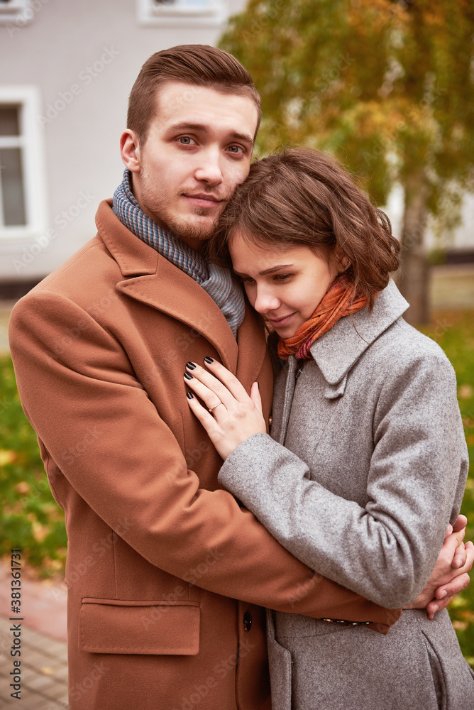Young beautiful couple walking and hugging in the autumn park
Young beautiful couple walking and hugging in the autumn park