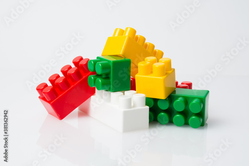 Many multi-colored cubes of blocks of children s constructor on a white background