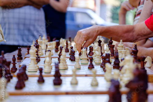 older people do a chess tournament. chess part closeup