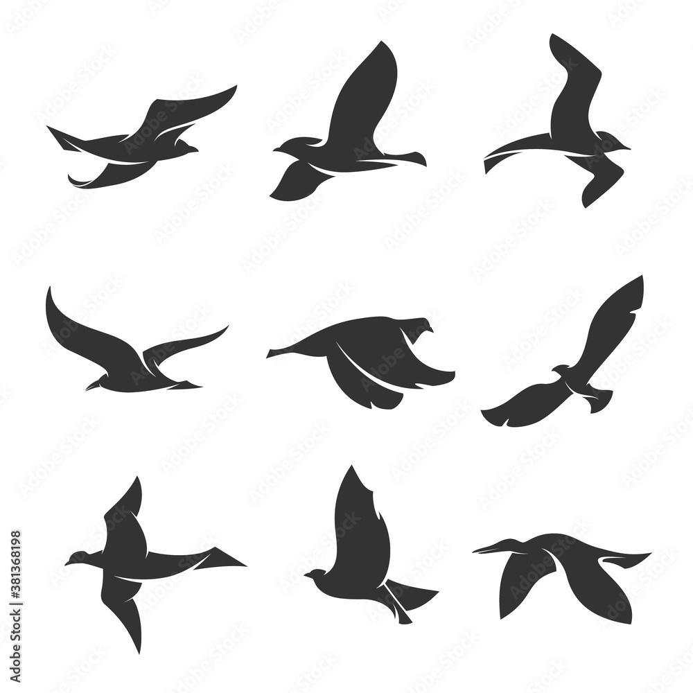 set of silhouettes of birds in motion on a white background 