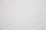 Wall with white textured plaster. Plaster in the form of blots on the wall