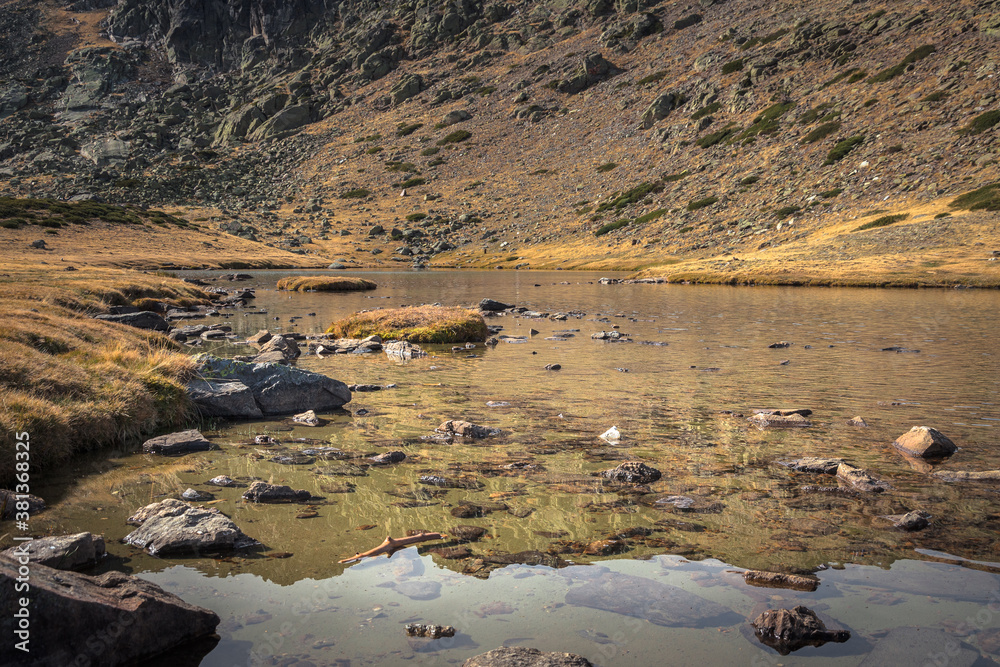 Lake on a rocky mountain landscape on Guadarrama mountain range, Peñalara, Madrid, Spain
