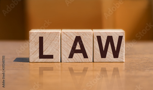 law - word in wooden blocks on wooden table