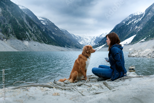 dog and a girl at mountain lake. hiking with pet. Woman and pet travels © annaav