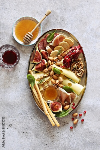 The Ultimate Appetizer Platter. Charcuterie Board with various of cured meat, chees, nuts and fruits. photo