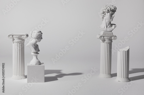 Background for product presentation. Antique columns ans statues on white background