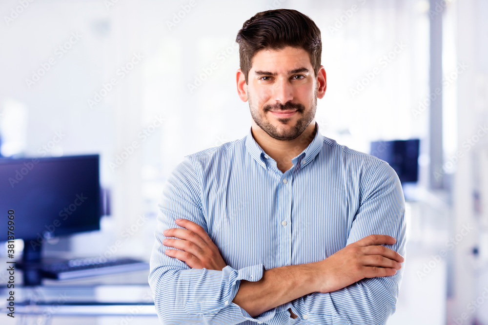 Confident businessman close-up portrait while standing at the office Confident businessman close-up portrait while standing at the office