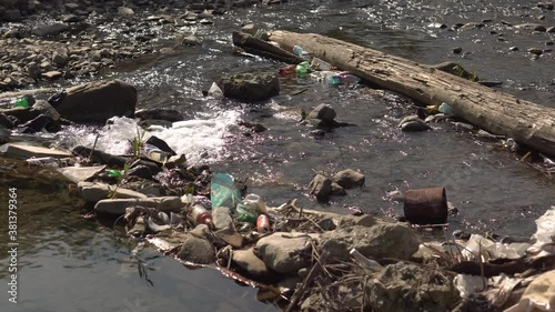 Household waste in the mountain river Tereblya in the village of Kolochava in the Transcarpathian region of Ukraine. Water clogged with plastic bottles, bags and other waste. Environmental pollution