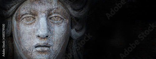 Banner with ancient aged sculpture of beautiful Venetian Renaissance Era woman face in Venice, Italy, isolated at black background, closeup, details.