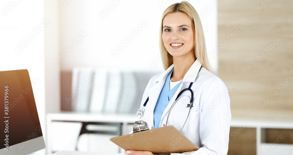 Doctor woman controls medication history records and exam results while using clipboard in sunny hospital . Medicine and healthcare concept Doctor woman controls medication history records and exam results while using clipboard in sunny hospital . Medicine and healthcare concept