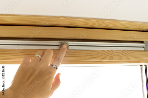 Hand close ventilation system of new skylight mansard window in an attic room. photo