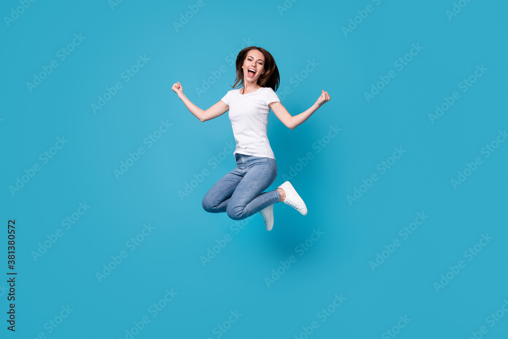 Full length body size view of her she attractive pretty slim skinny glad overjoyed lucky cheerful girl jumping celebrating having fun vacation isolated bright vivid shine vibrant blue color background