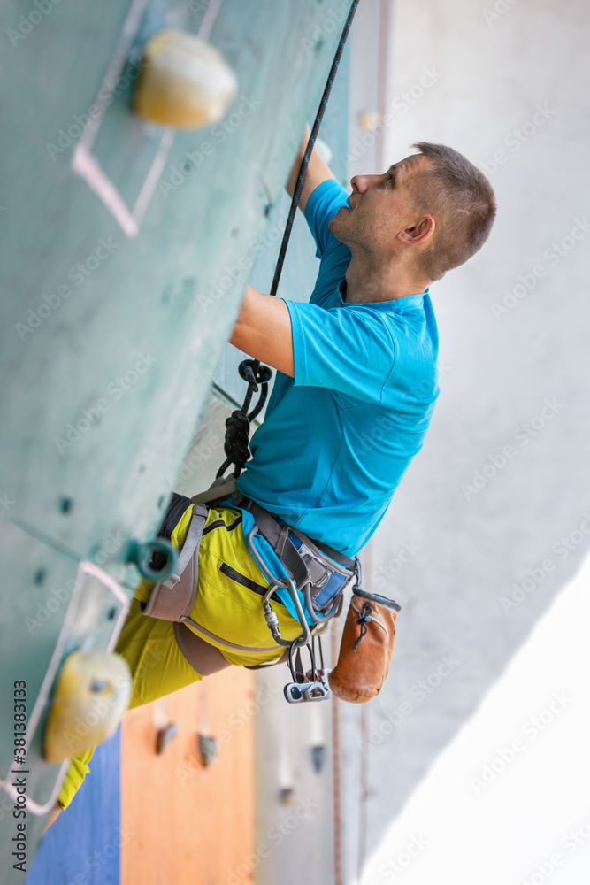 Young man climber on the climbing wall Young man climber on the climbing wall