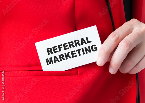 Businessman showing card with text Referral Marketing