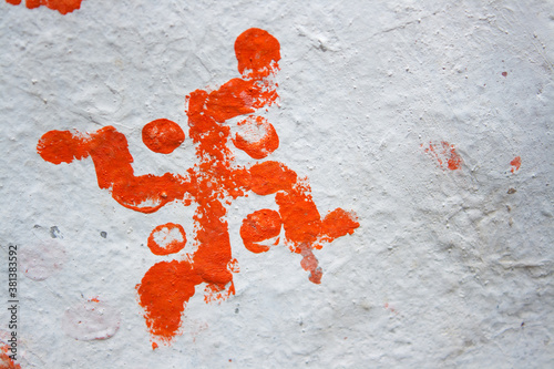 Red swastika symbol on white wall