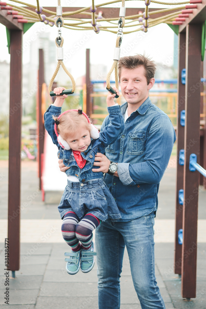 Obraz premium Father and little daughter playing in the playground