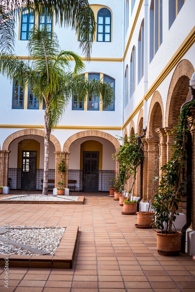 courtyard with arches and palm trees in a Spanish castle. architecture of Spain
