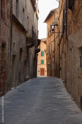 Medieval town Pienza in Val d'Orcia, Tuscany, Italy, narrow alley, old houses on both sides