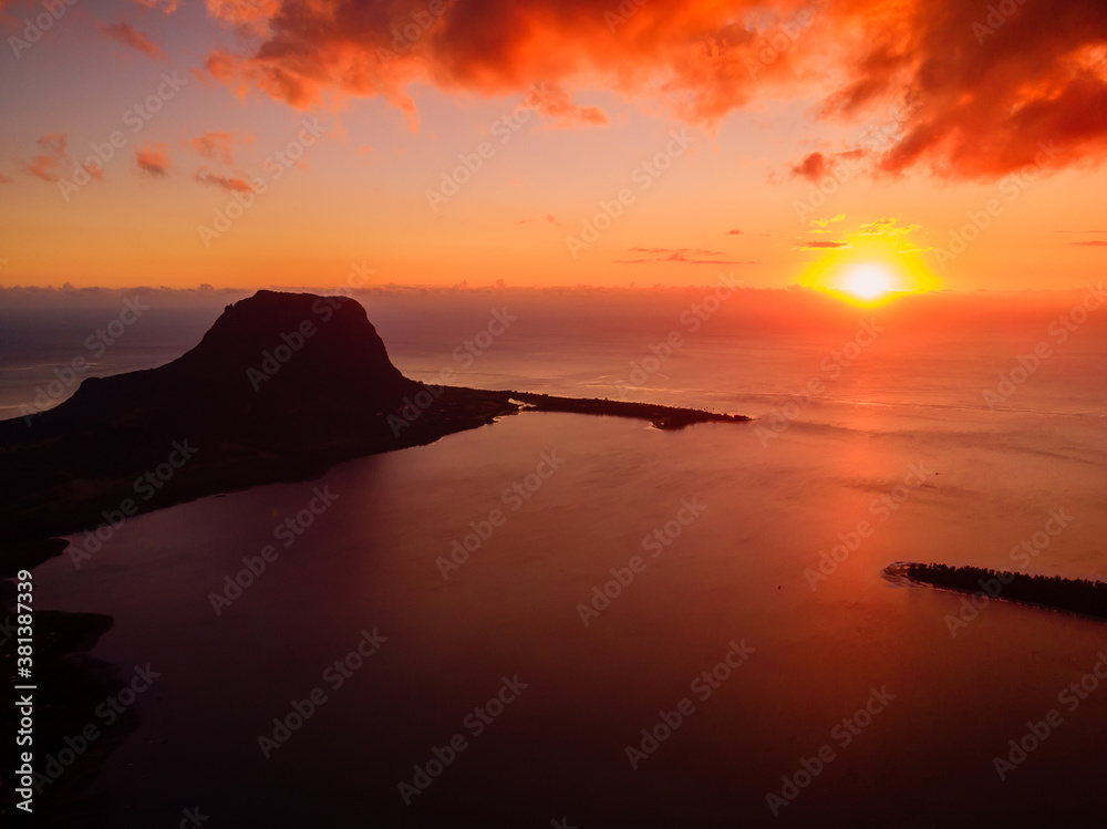 Sunset and Le Morn mountain with ocean in Mauritius island. Aerial view